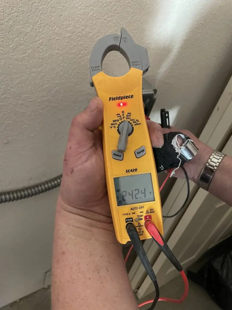 Voltage testing with clamp meter during Recessed Lighting Installation in Argyle